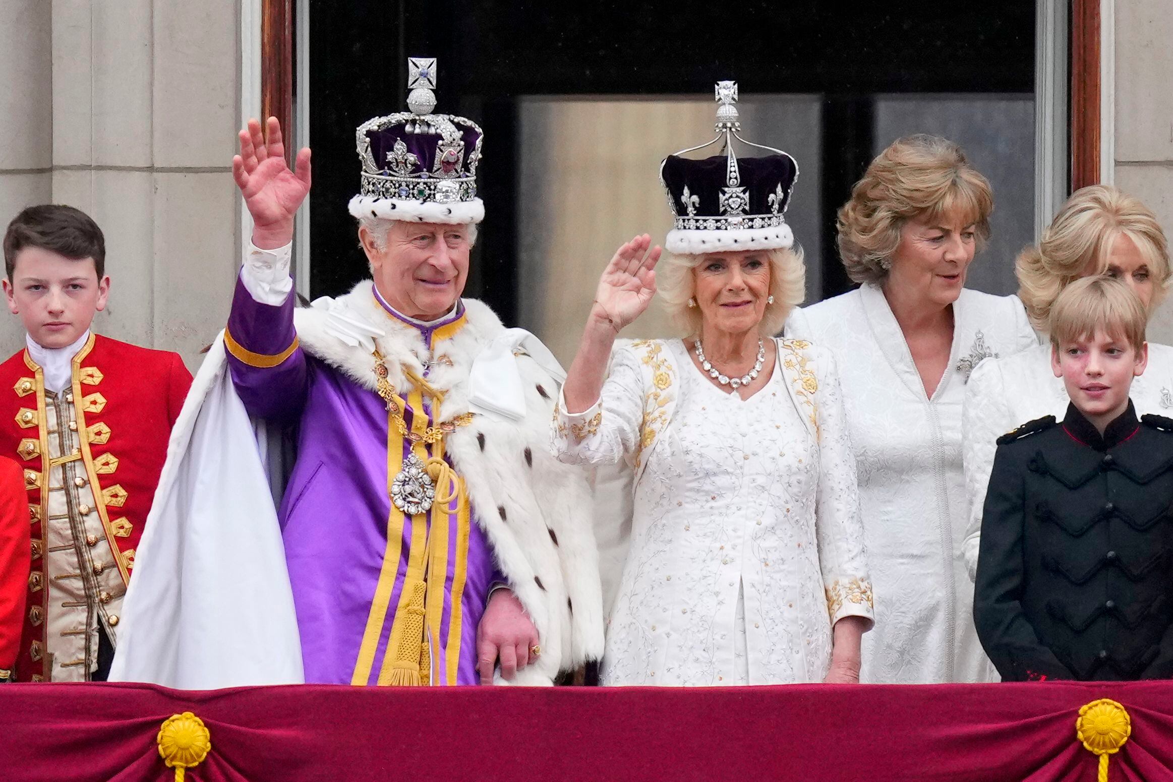 Britain's King Charles III and Queen Camilla wave to the crowds from the balcony of Buckingham Palace after their coronation ceremony, in London, Saturday, May 6, 2023. (AP Photo/Petr David Josek)