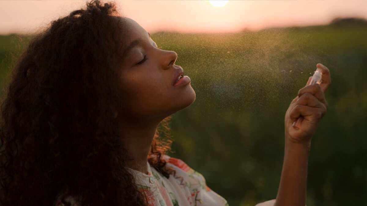 Mujer aplicándose mujer al aire libre